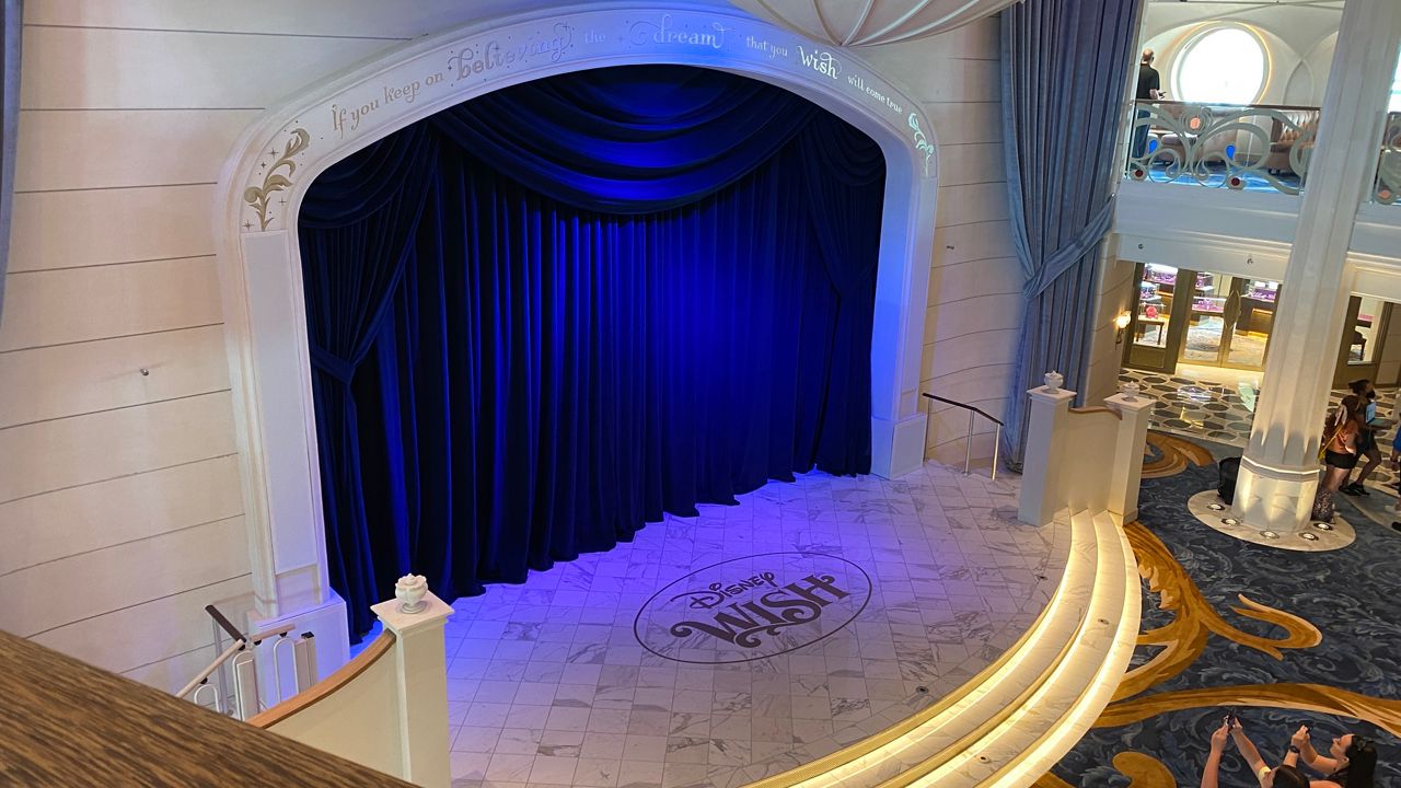 Visitors to the Disney Wish take in the stage in the ship's Grand Hall, which is one of the first thing passengers see when they board. (Spectrum News 13/Ashley Carter)