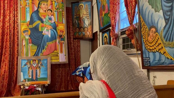 Wanda Allen-Abraha praying in Ethiopian church