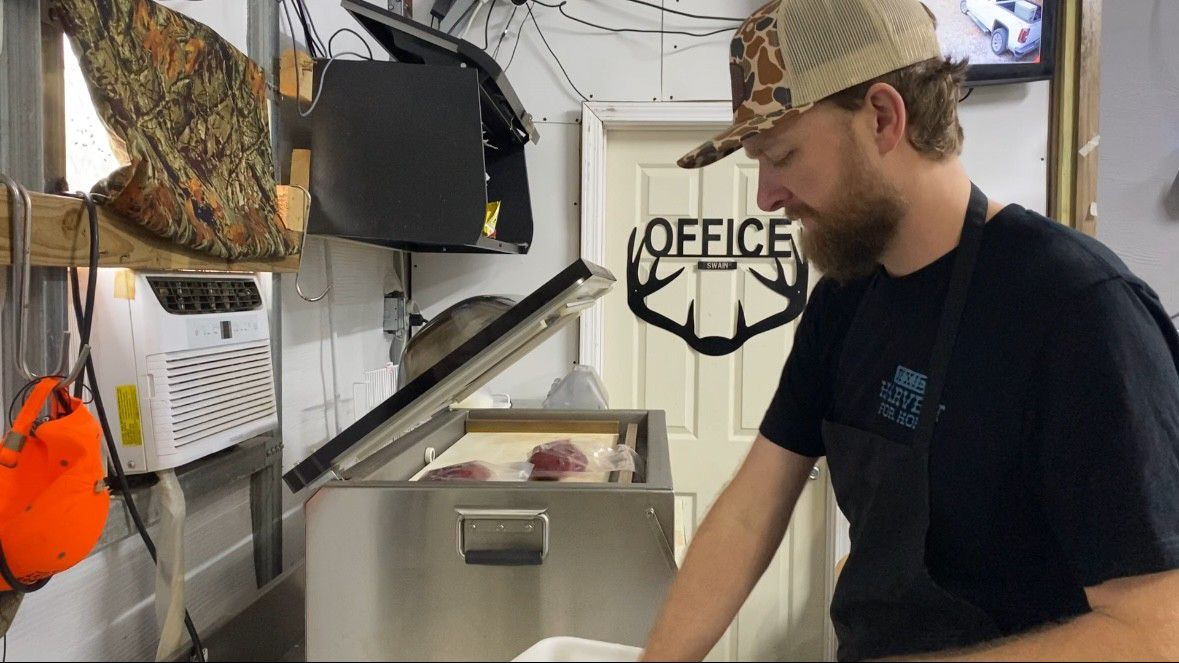 Myles Swain prepares venison for donation.  (Spectrum News 1/Natalie Mooney)