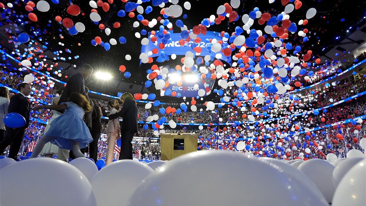 Democratic presidential nominee Vice President Kamala Harris, second gentleman Doug Emhoff, Democratic vice presidential candidate Minnesota Gov. Tim Walz and his wife Gwen Walz and members of their families stand on stage as balloons drop on the final night of the Democratic National Convention in Chicago, Thursday, Aug. 22, 2024. (Kent Nishimura/The New York Times via AP, Pool)