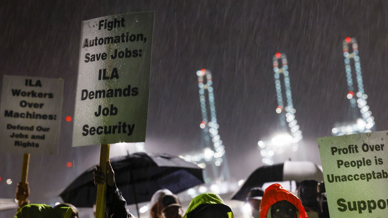 Hundreds of longshoremen strike together outside of the Virginia International Gateway in Portsmouth, Va., Tuesday, Oct. 1, 2024. (Billy Schuerman/The Virginian-Pilot via AP)