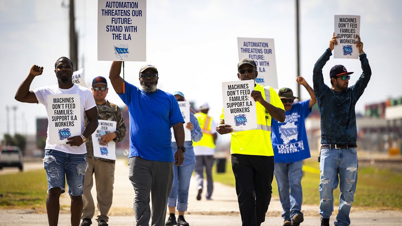 Longshoremen walk the picket line at the Barbours Cut Container Terminal during the first day of a dockworkers strike on Tuesday, Oct. 1, 2024, in Houston. (AP Photo/Annie Mulligan)