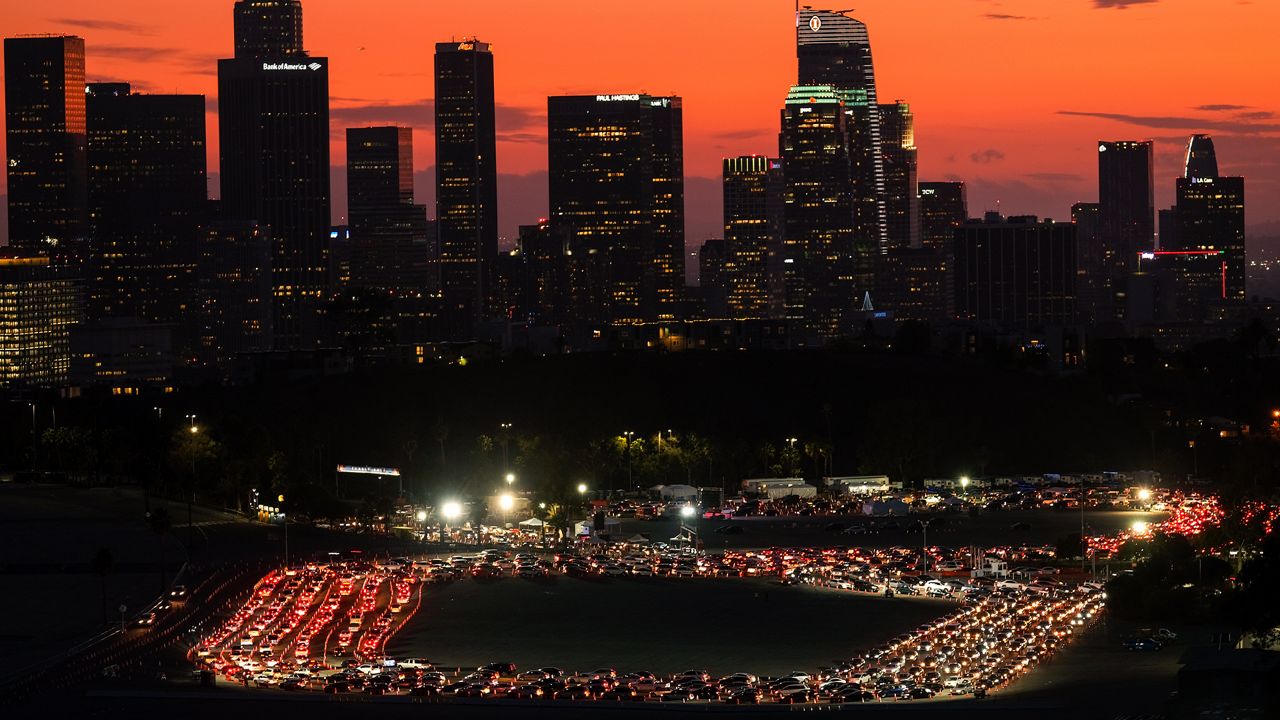 Motorists wait in lines to take a coronavirus test in a parking lot at Dodger Stadium, Monday, Jan. 4, 2021, in Los Angeles. (AP Photo/Ringo H.W. Chiu)