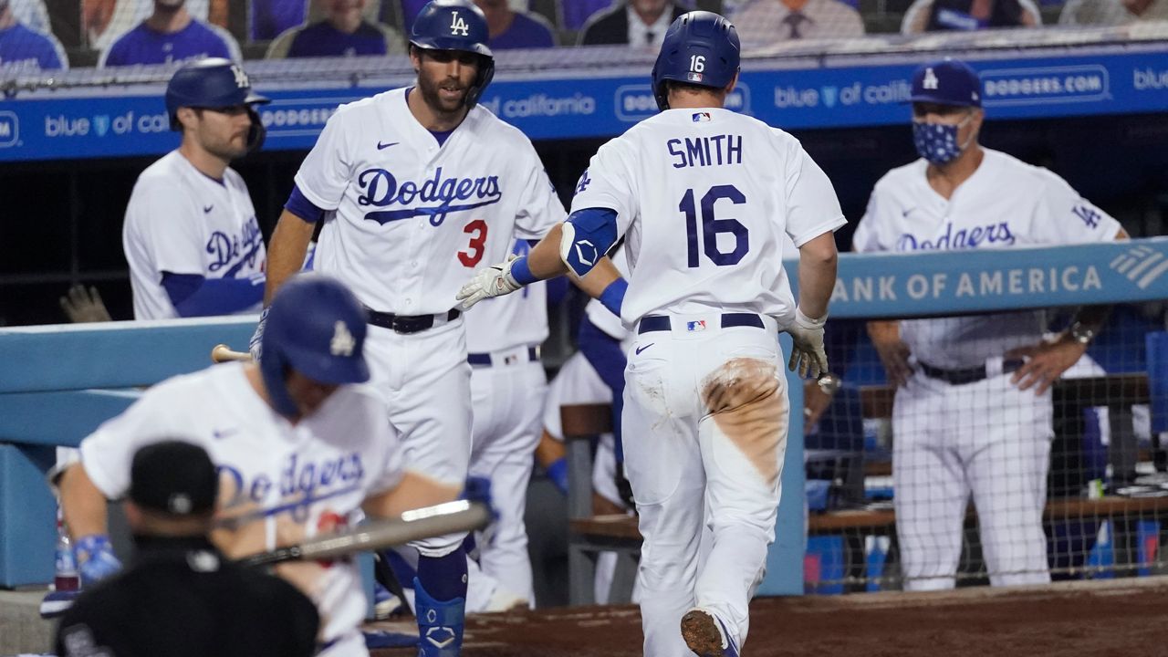 Los Angeles Dodgers' Will Smith returns to the dugout after hitting a home run during the eighth inning of the team's baseball game against the Los Angeles Angels on Saturday, Sept. 26, 2020, in Los Angeles. (AP Photo/Ashley Landis)