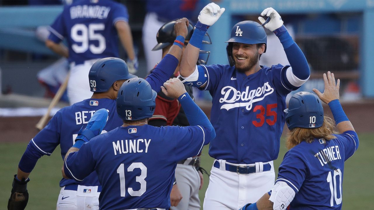Los Angeles Dodgers' Cody Bellinger (35) is met at home plate after hitting a grand slam during the first inning of an exhibition baseball game against the Arizona Diamondbacks Sunday, July 19, 2020, in Los Angeles. (AP Photo/Marcio Jose Sanchez)