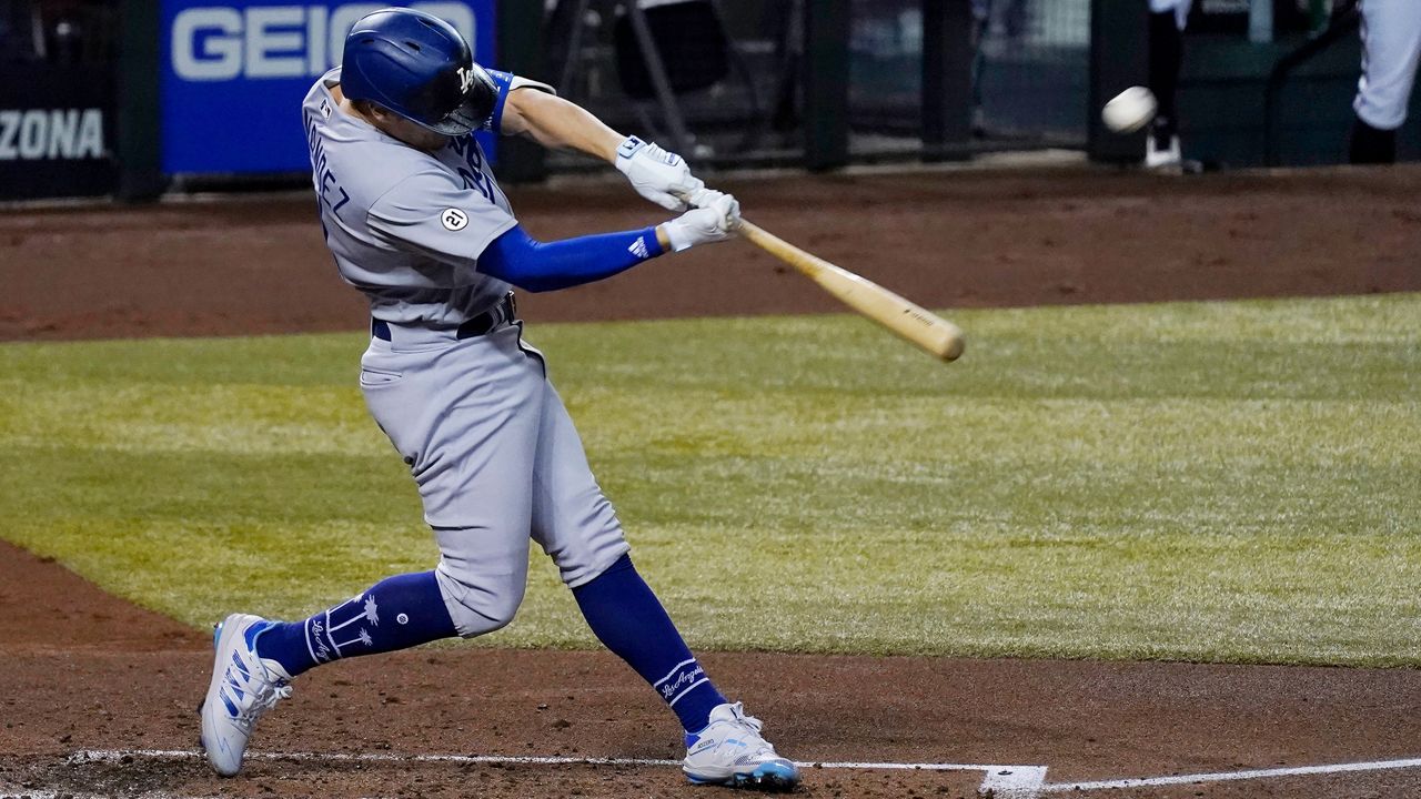Los Angeles Dodgers' Enrique Hernandez connects for a home run against the Arizona Diamondbacks during the second inning of a baseball game Wednesday, Sept. 9, 2020, in Phoenix. (AP Photo/Ross D. Franklin)