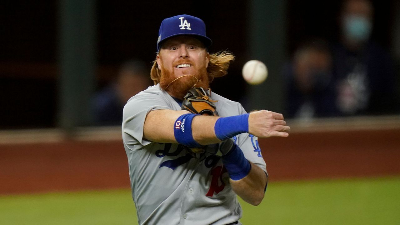 Los Angeles Dodgers third baseman Justin Turner throws out Atlanta Braves' Travis d'Arnaud out at first during the second inning in Game 4 of a baseball National League Championship Series Thursday, Oct. 15, 2020, in Arlington, Texas. (AP Photo/Eric Gay)