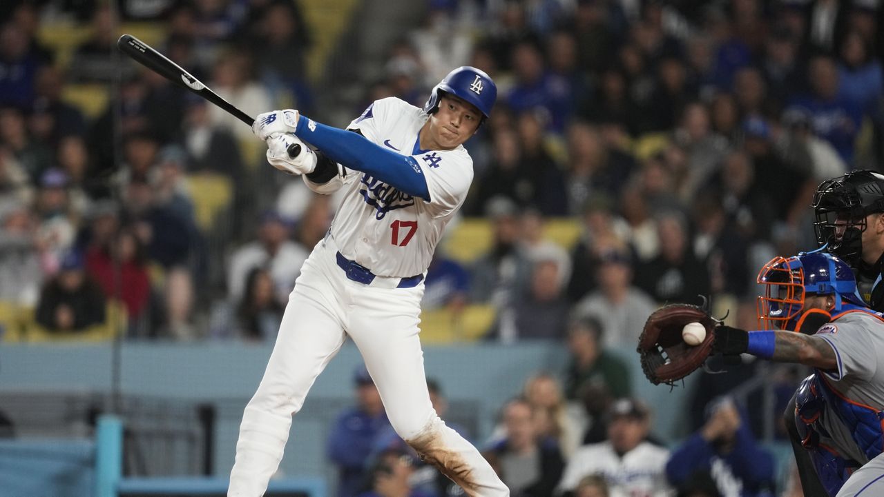 Los Angeles Dodgers designated hitter Shohei Ohtani (17) swings a strike during the seventh inning of a baseball game against the New York Mets in Los Angeles, Friday, April 19, 2024. (AP Photo/Ashley Landis)