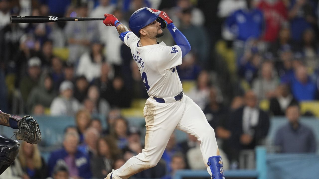 Los Angeles Dodgers' Andy Pages singles during the eleventh inning of a baseball game against the Atlanta Braves in Los Angeles, Friday, May 3, 2024. Will Smith scored. The Dodgers won 4-3. (AP Photo/Ashley Landis)