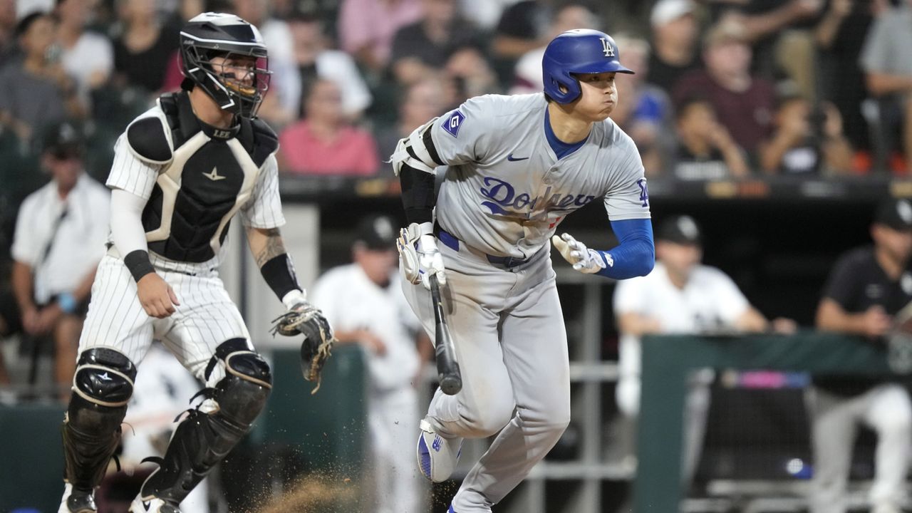 Los Angeles Dodgers' Shohei Ohtani and Chicago White Sox catcher Korey Lee watch Ohtani's RBI single off starting pitcher Chris Flexen during the fourth inning of a baseball game Tuesday, June 25, 2024, in Chicago. (AP Photo/Charles Rex Arbogast)