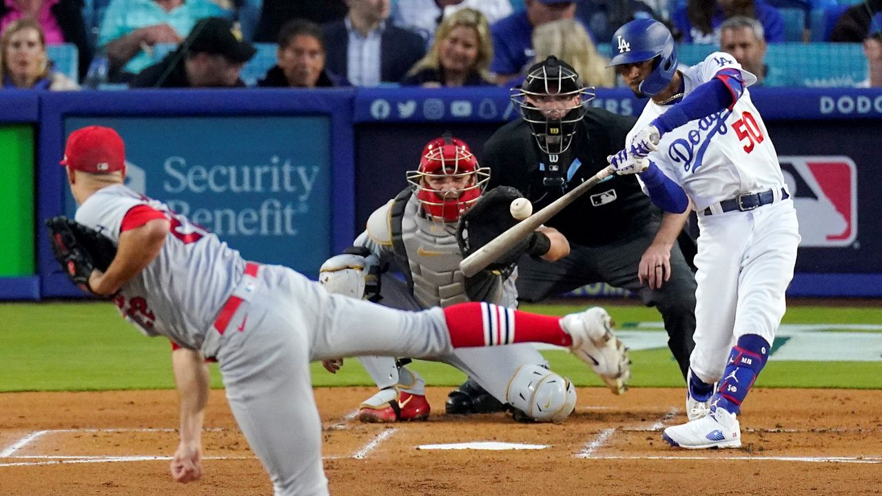 Dodgers clinch postseason berth in 8-4 win over D-backs