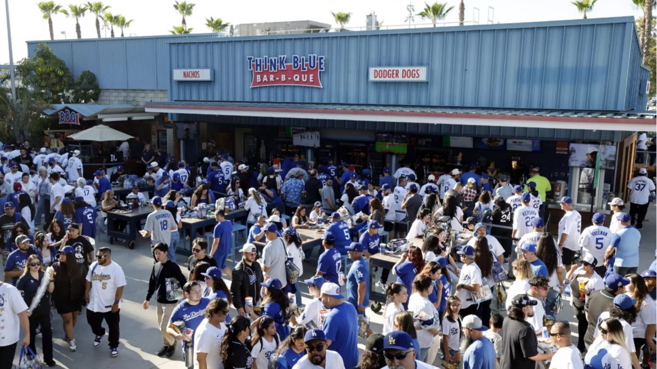 Fans line up to buy food at a concession stand before a game in April 2025 at Dodger Stadium. (For The Times/Kevork Djansezian)