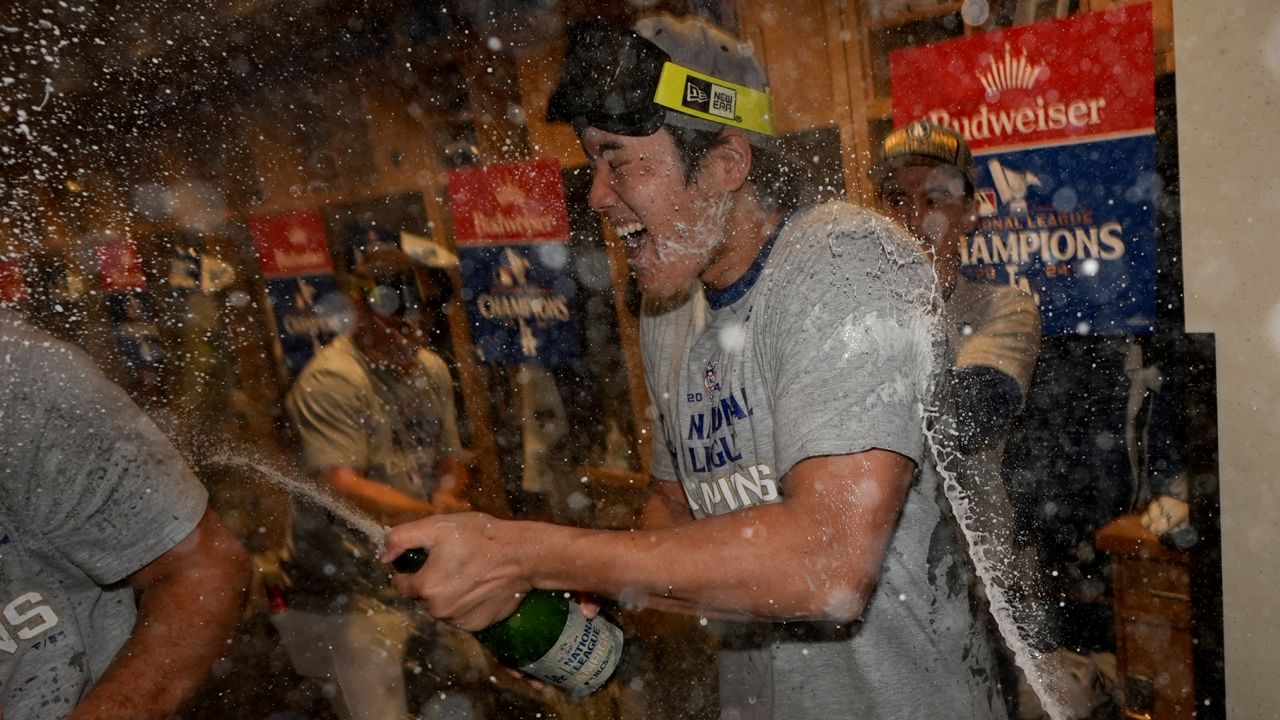 Los Angeles Dodgers Shohei Ohtani celebrates in the locker room after their win against the New York Mets in Game 6 of a baseball NL Championship Series on Sunday in LA. (AP Photo/Ashley Landis)