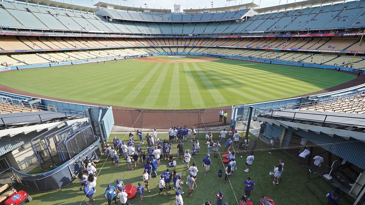 Fans mill about in the Centerfield Plaza area at Dodger Stadium prior to a baseball game between the Los Angeles Dodgers and the Philadelphia Phillies Tuesday, June 15, 2021, in Los Angeles. (AP Photo/Mark J. Terrill)