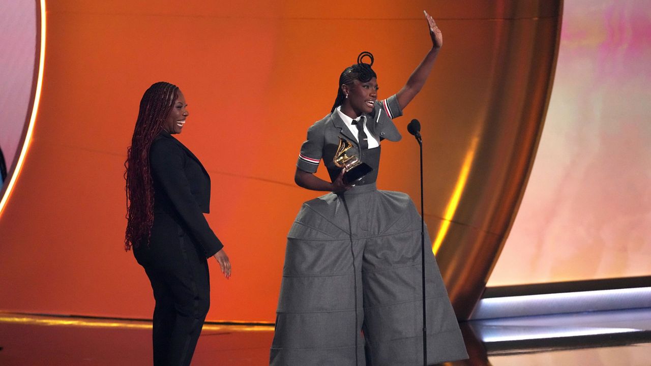 Doechii, center, accepts the award for best rap album for "Alligator Bites Never Heal" during the 67th annual Grammy Awards on Sunday, Feb. 2, 2025, in Los Angeles. Celesia Moore looks on from left. (AP Photo/Chris Pizzello)