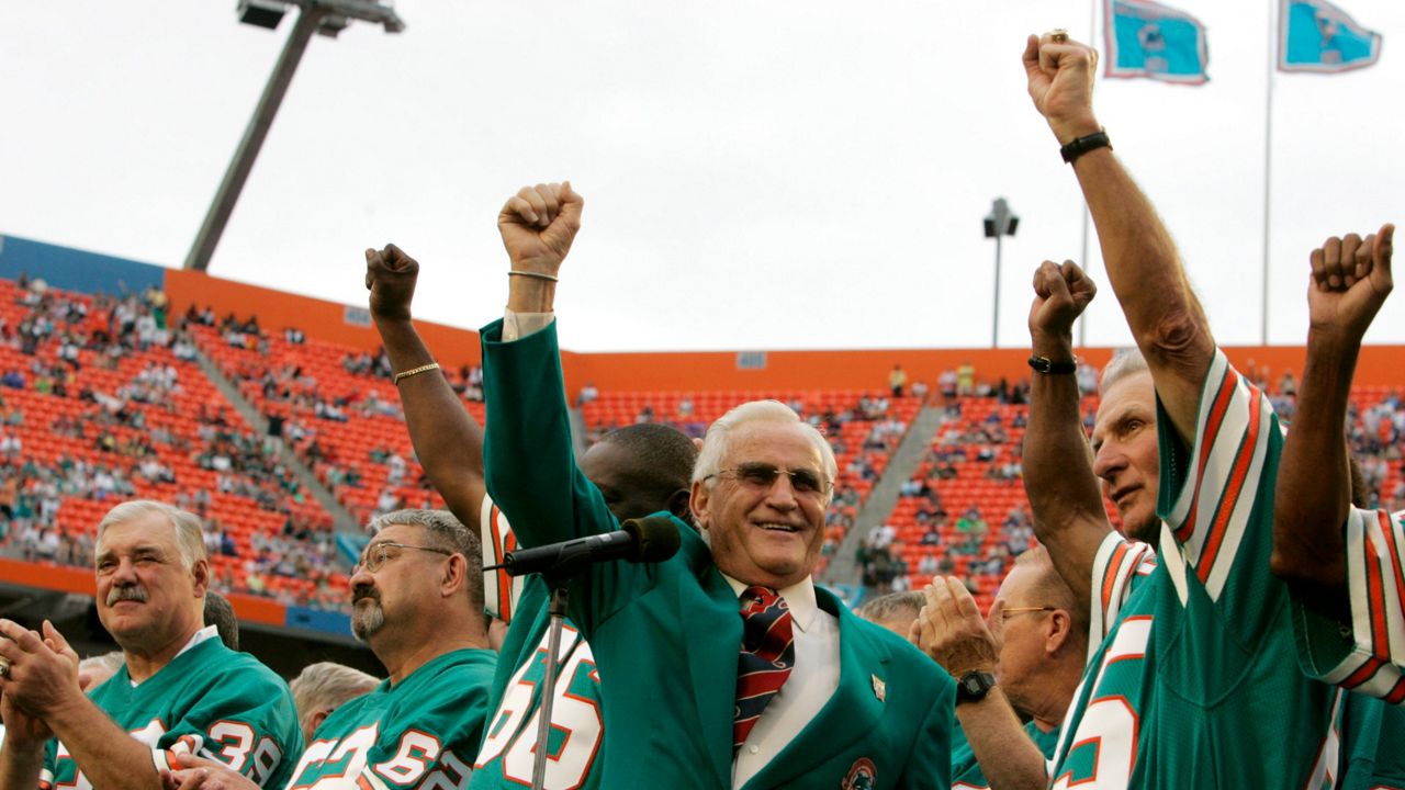 Former Syracuse football star Larry Csonka (left) is honored along with late coach Don Shula (center) during a tribute to the 1972 unbeaten Miami Dolphins.