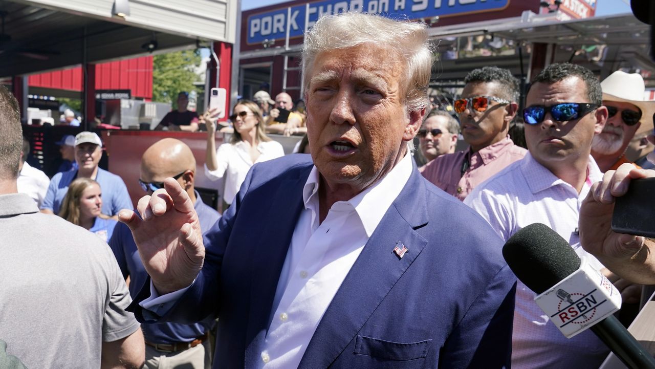 Republican presidential candidate and former President Donald Trump speaks while visiting the Iowa Pork Producers tent at the Iowa State Fair on Saturday in Des Moines. (AP Photo/Charlie Neibergall)