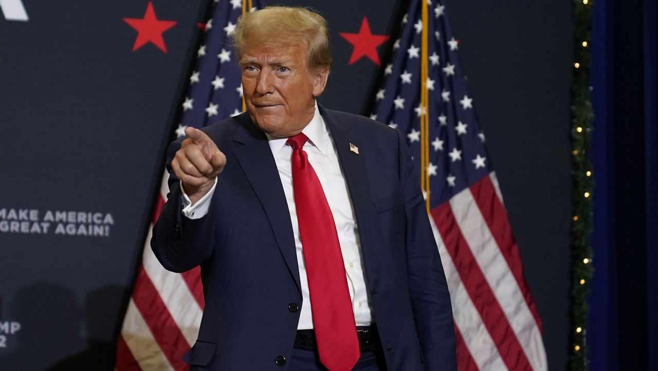 Former President Donald Trump greets supporters as he arrives at a commit-to-caucus rally, Tuesday, Dec. 19, 2023, in Waterloo, Iowa. (AP Photo/Charlie Neibergall)