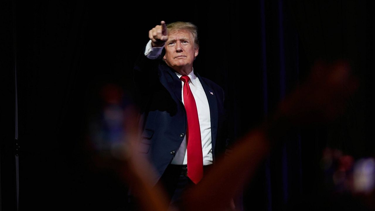 Former President Donald Trump points to supporters after speaking at a Turning Point Action gathering in Phoenix on July 24. (AP Photo/Ross D. Franklin, File)