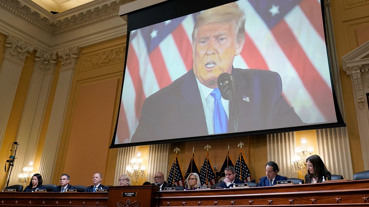 A video of former President Donald Trump is shown on a screen in Washington on Monday, Dec. 19, 2022.