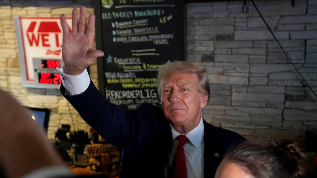 Former President Donald Trump greets supporters at the Treehouse Pub & Eatery, Wednesday, Sept. 20, 2023, in Bettendorf, Iowa. (AP Photo/Charlie Neibergall)