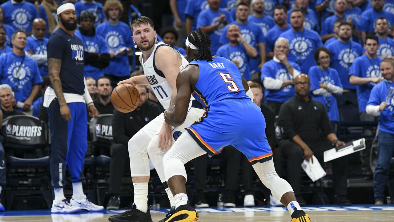 Dallas Mavericks guard Luka Doncic (77) works the floor against Oklahoma City Thunder guard Luguentz Dort (5) during the first half in Game 2 of an NBA basketball second-round playoff series, Thursday, May 9, 2024, in Oklahoma City. (AP Photo/Kyle Phillips)