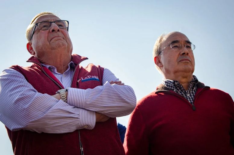 In this Oct. 12, 2022, file photo, former Gov. Paul LePage, left, and former U.S. Rep. Bruce Poliquin of Maine's 2nd District listen to lobstermen speak at a rally on the Portland waterfront. 