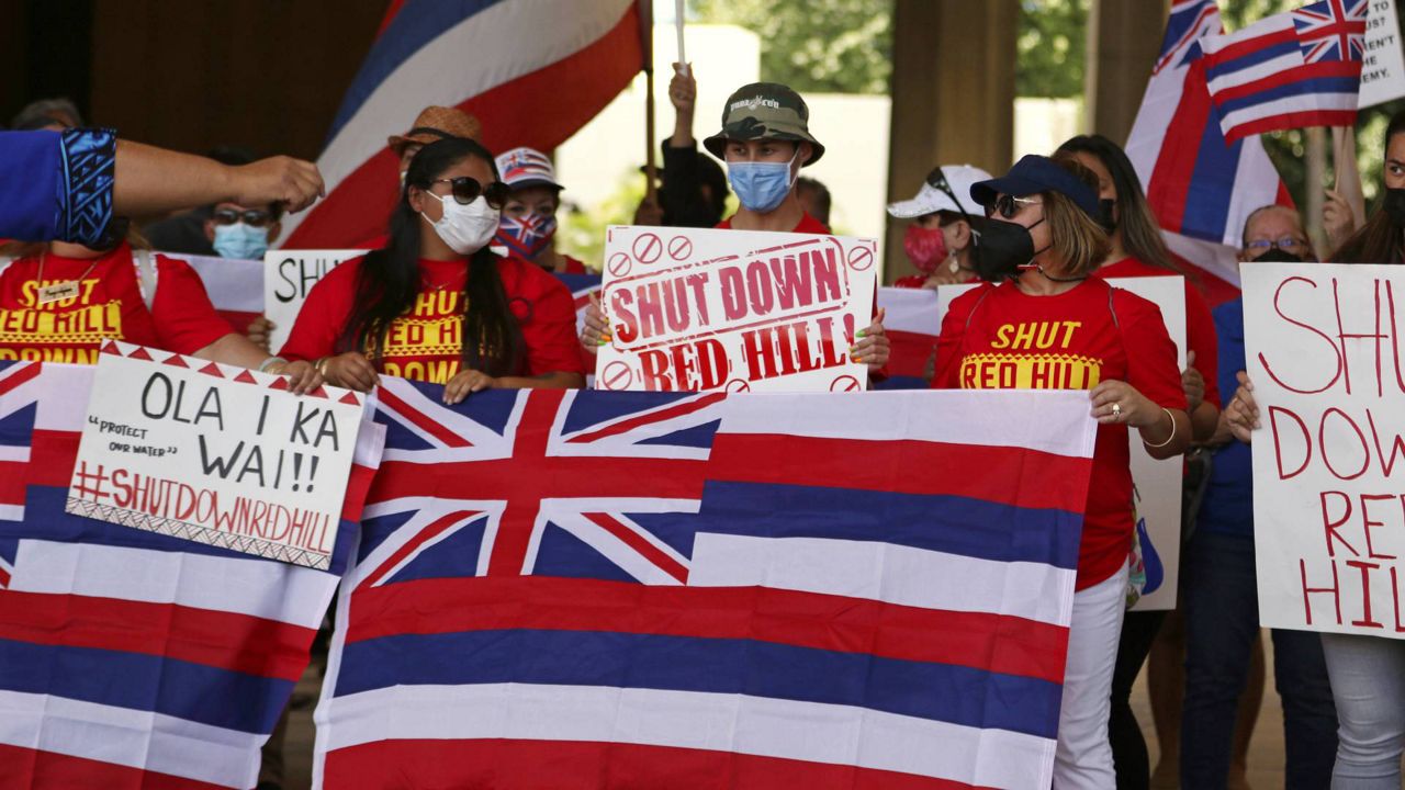 A group of demonstrators gather at the Hawaii state capitol for a rally over water contamination by the U.S. Navy near Pearl Harbor on Feb. 11, 2022, in Honolulu. Native Hawaiians who revere water in all its forms as the embodiment of a Hawaiian god say the Navy's acknowledgement that jet fuel leaked into Pearl Harbor's tap water has deepened the distrust they feel toward the U.S. military. (AP Photo/Caleb Jones)