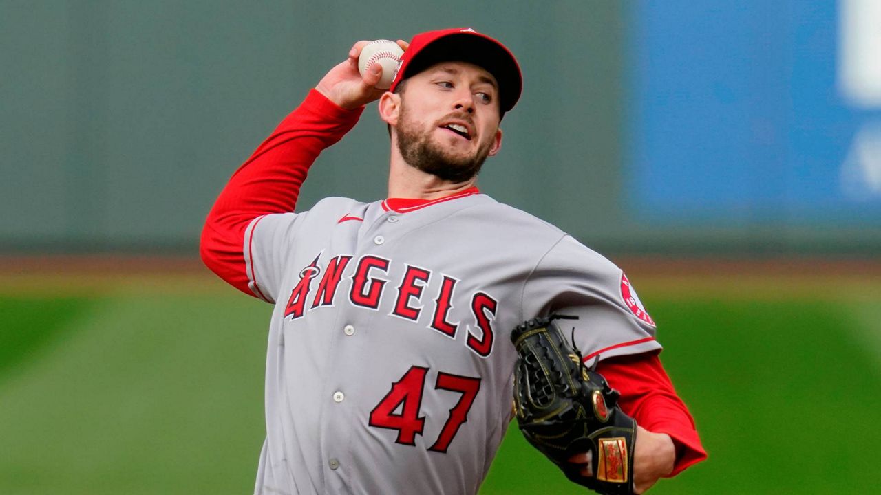 Los Angeles Angels starting pitcher Griffin Canning throws against the Seattle Mariners in the first inning of a baseball game Saturday, May 1, 2021, in Seattle. Canning won’t be ready for opening day after a setback in his recovery from a back injury. (AP Photo/Elaine Thompson, File)