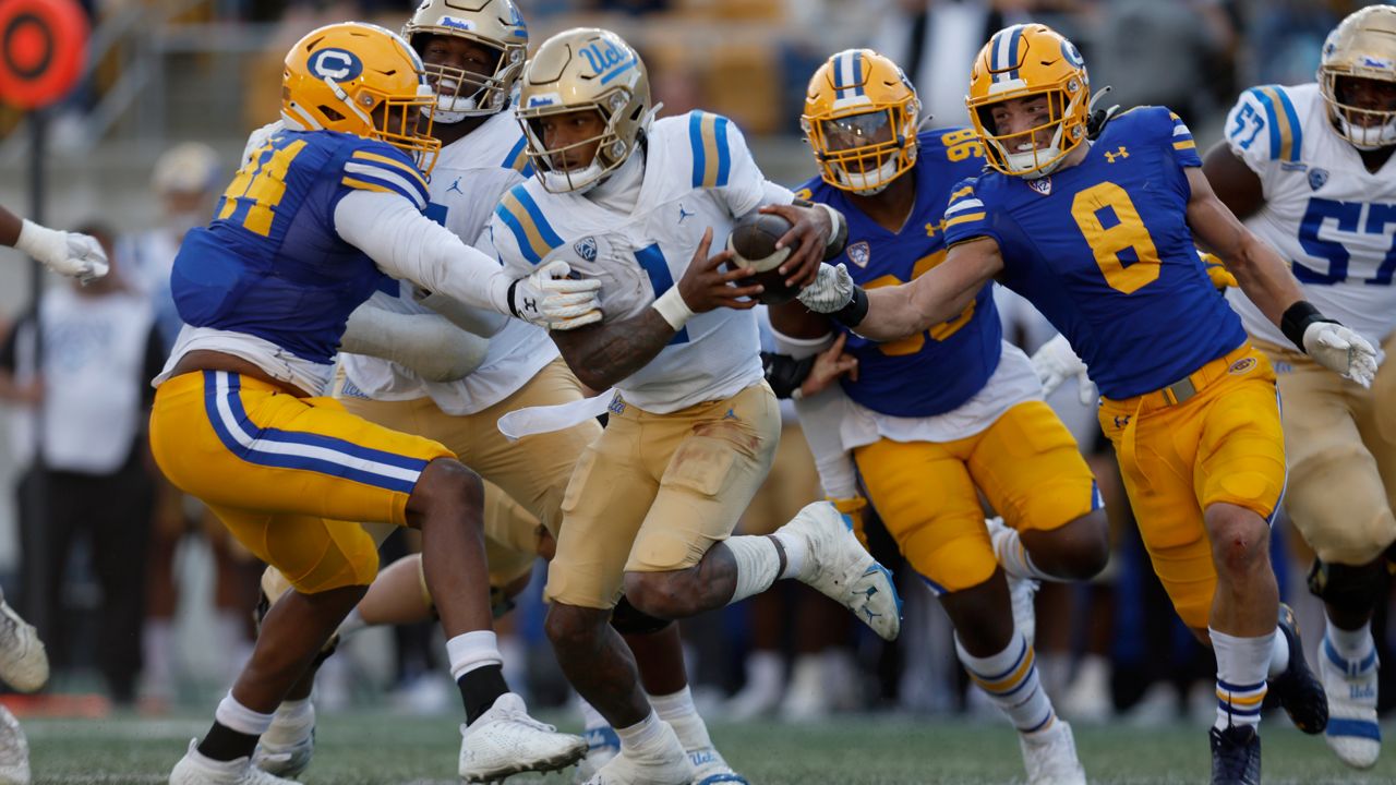 UCLA quarterback Dorian Thompson-Robinson (1) runs against California defensive end Xavier Carlton (44) and linebacker Jackson Sirmon (8) during the first half of an NCAA college football game in Berkeley, Calif., Friday, Nov. 25, 2022. (AP Photo/Jed Jacobsohn)