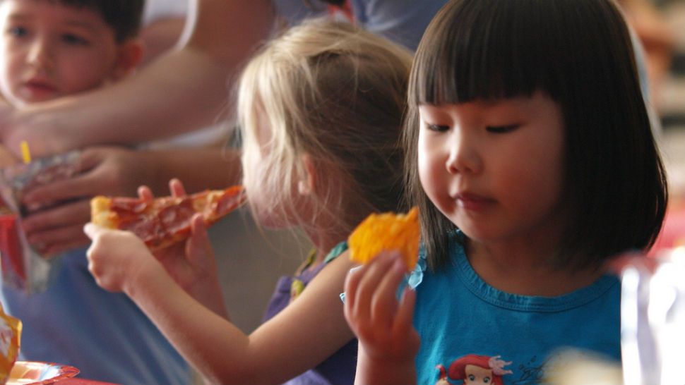 Little girl contemplates Dorito. mliu92, Flickr