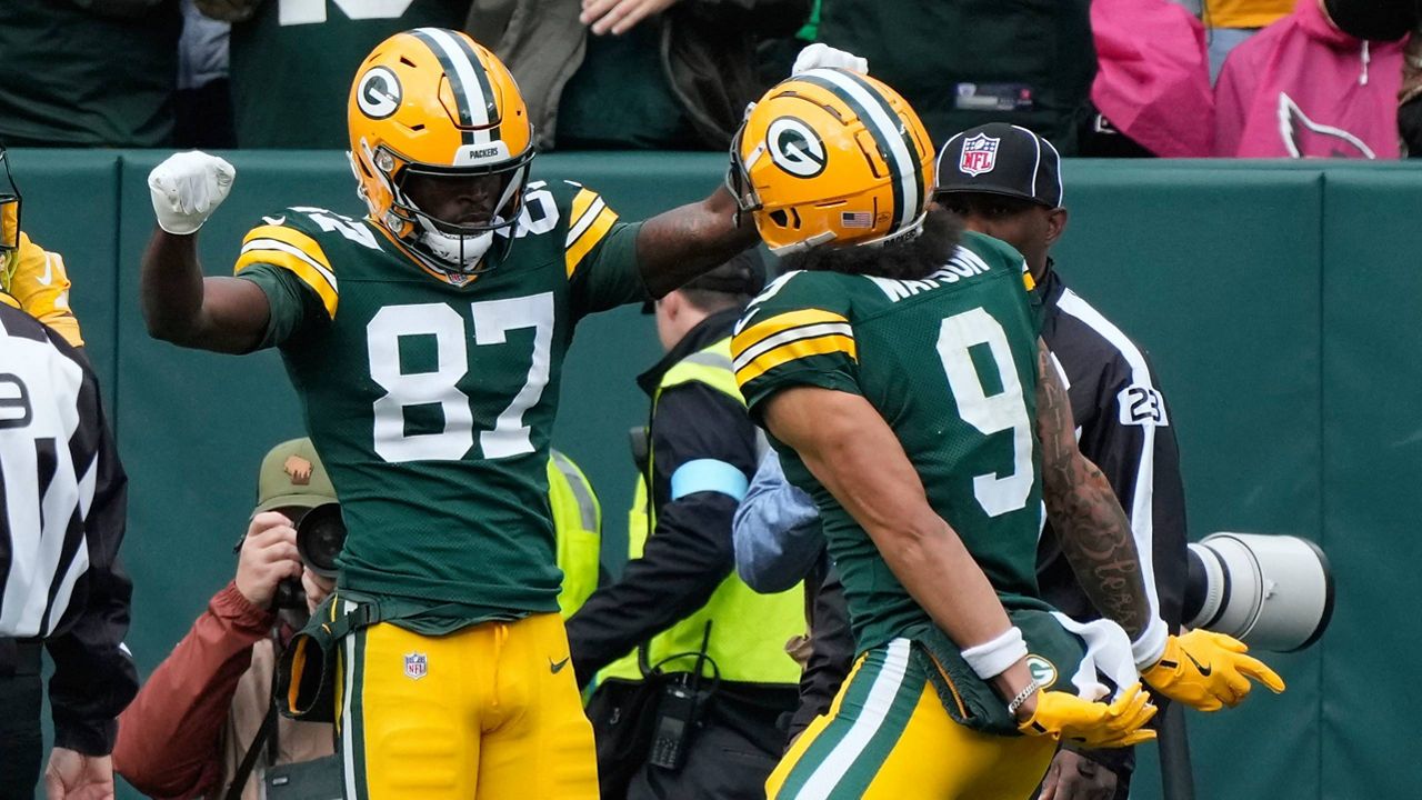 Green Bay Packers wide receiver Romeo Doubs (87) celebrates his 20-yard reception for a touchdown with teammate wide receiver Christian Watson