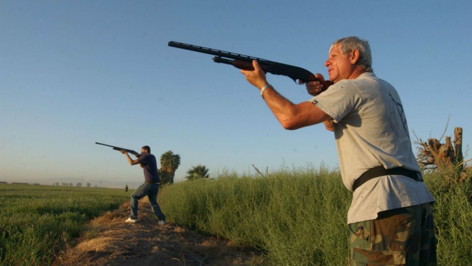 Two men shooting at doves on the first day of the hunting season. (AP Photo/Imperial Valley Press, Cuauhtemoc Beltran)