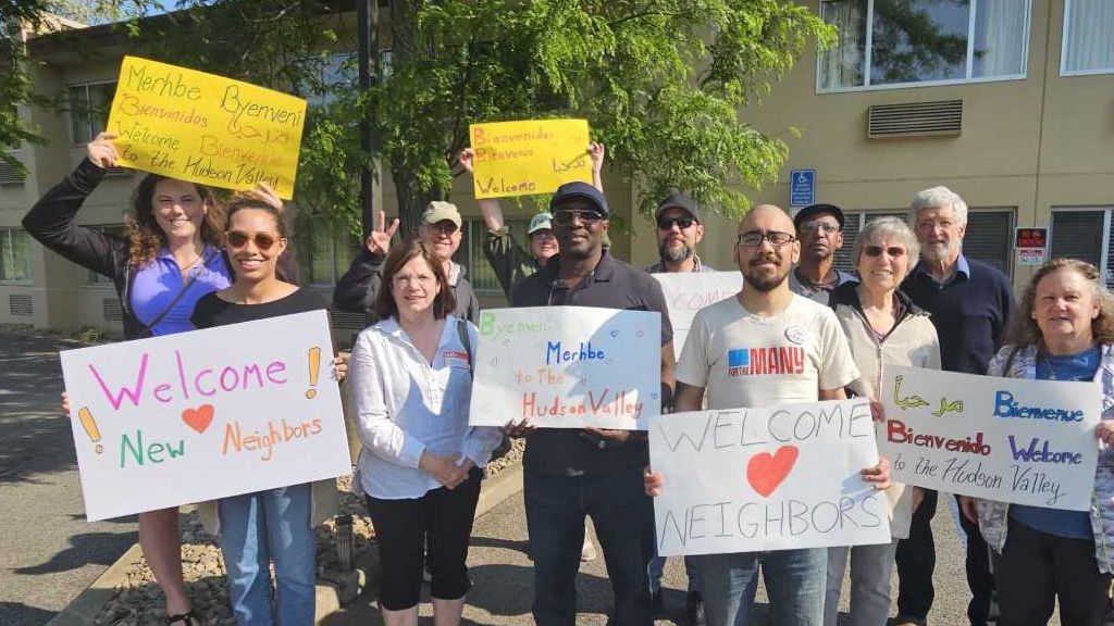 Crowd with signs at hotel