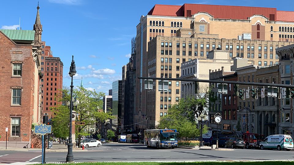 downtown albany as seen on a sunny day from the grass in front of the state capitol building