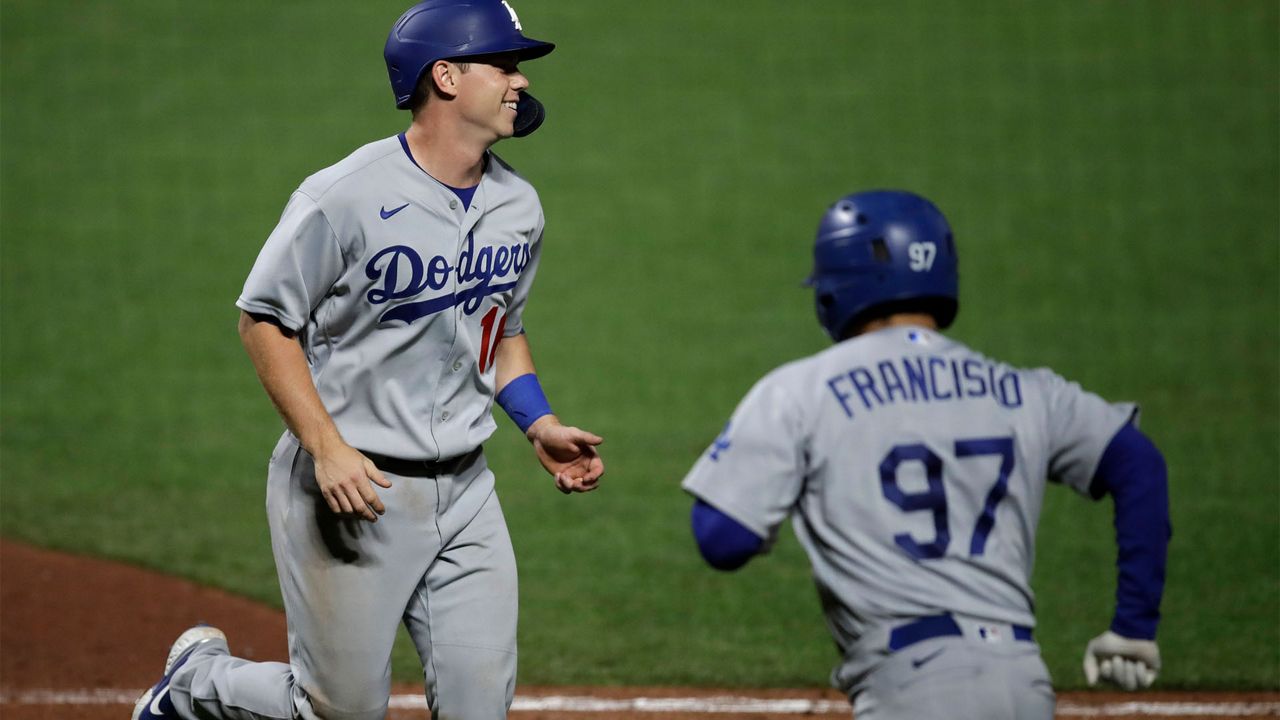 Los Angeles Dodgers' Will Smith, left, smiles after scoring against the San Francisco Giants in the eleventh inning of a baseball game Tuesday, Aug. 25, 2020, in San Francisco. (AP Photo/Ben Margot)