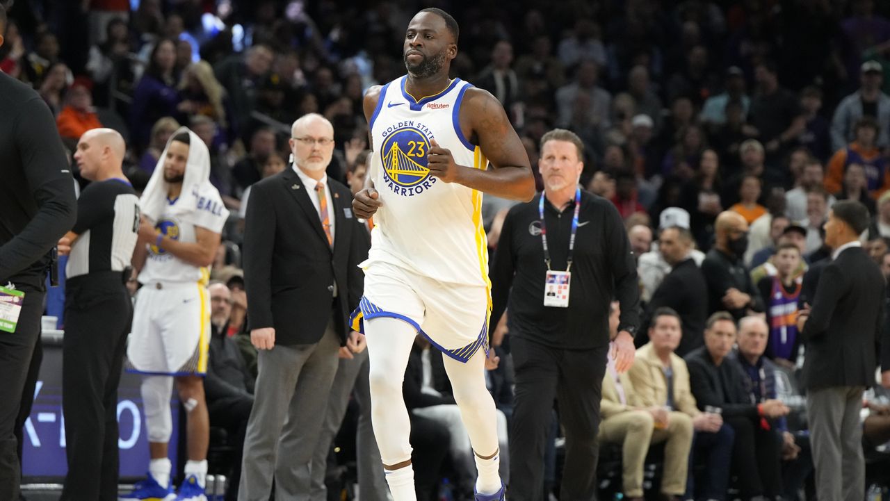 Golden State Warriors forward Draymond Green (23) jogs off the court after getting ejected during the second half of an NBA basketball game against the Phoenix Suns, Tuesday, Dec. 12, 2023, in Phoenix. (AP Photo/Rick Scuteri)