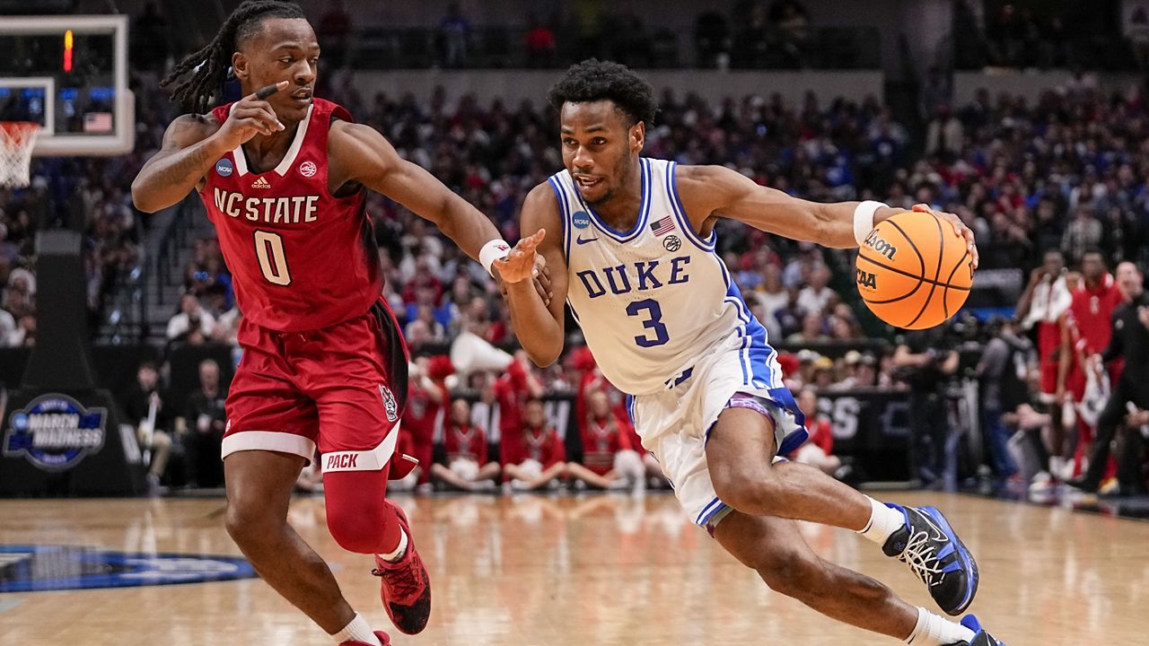 Duke's Jeremy Roach (3) drives against North Carolina State's DJ Horne (0) during the second half of an Elite Eight college basketball game in the NCAA Tournament in Dallas, Sunday, March 31, 2024. (AP Photo/Tony Gutierrez)