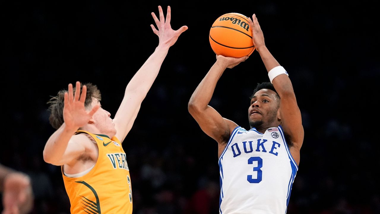 Duke guard Jeremy Roach, right, shoots a 3-point basket over Vermont guard TJ Hurley during a first-round college basketball game in the men's NCAA Tournament on Friday, March 22, 2024, in New York. Duke won 64-47. (AP Photo/Mary Altaffer)