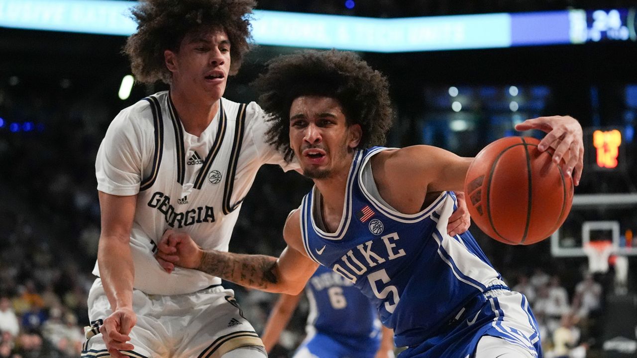 Duke guard Tyrese Proctor (5) dribbles against Georgia Tech guard Naithan George (1) during the first half of an NCAA college basketball game on Saturday, Dec. 21, 2024 in Atlanta. (AP Photo/Brynn Anderson)