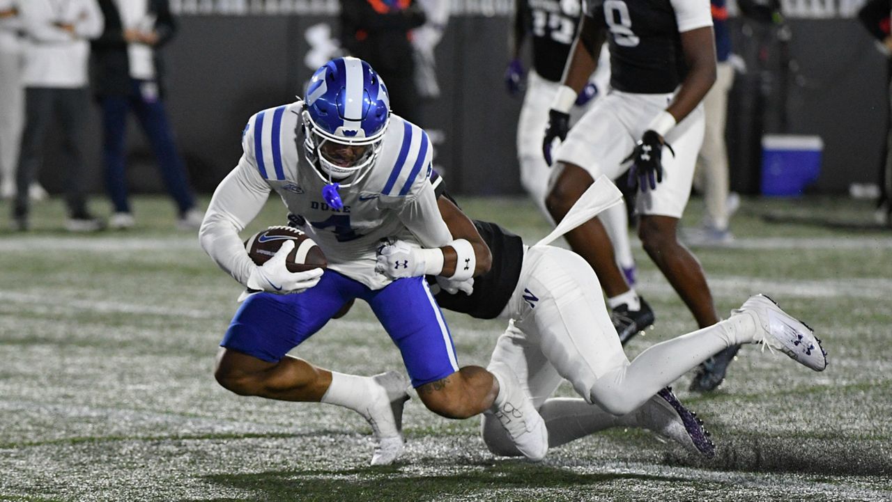 Duke wide receiver Eli Pancol (4) scores a touchdown past Northwestern defensive back Braden Turner (9) during an NCAA college football game Friday, Sept. 6, 2024, in Evanston, Ill. (AP Photo/Matt Marton)