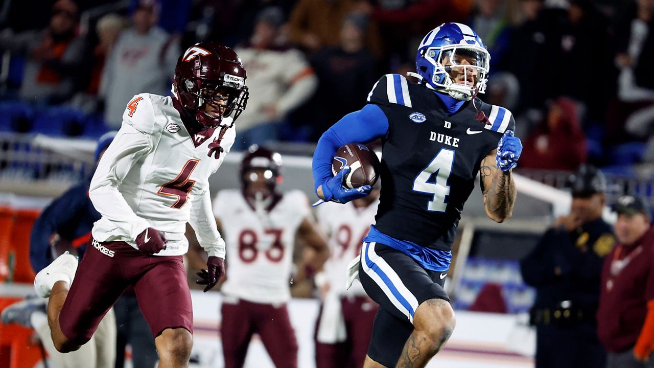 Duke's Eli Pancol, right, runs away from Virginia Tech's Mansoor Delane, left, on his way to a touchdown during the first half of an NCAA college football game in Durham, N.C., Saturday, Nov. 23, 2024. (AP Photo/Karl B DeBlaker)