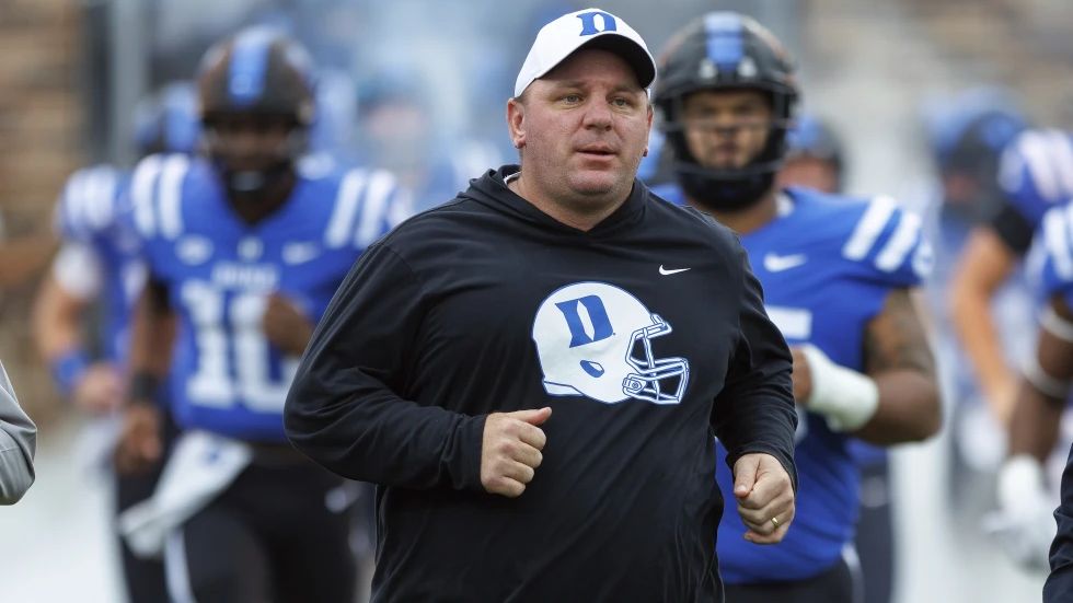 Duke head coach Mike Elko points at the video replay board after a holding penalty was called against his team during the second half of an NCAA college football game against Pittsburgh in Durham, N.C., Saturday, Nov. 25, 2023. (AP Photo/Ben McKeown)