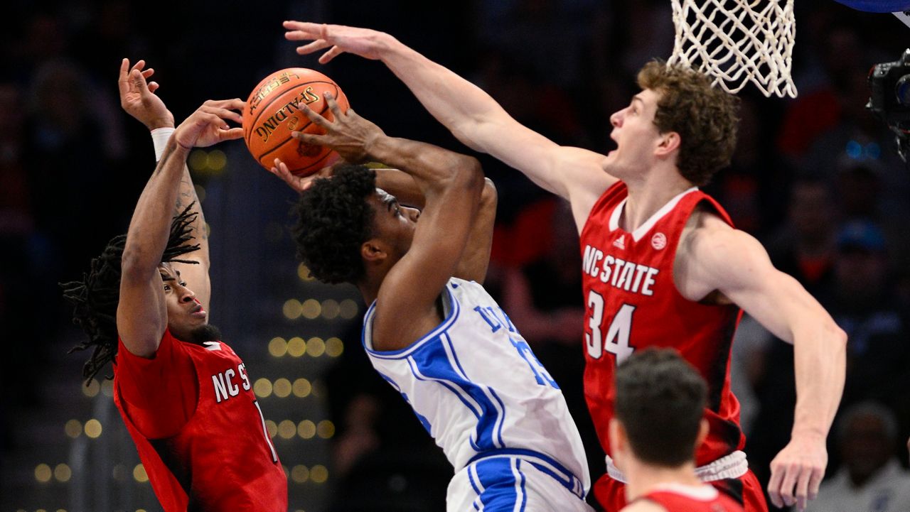 Duke forward Sean Stewart (13) goes up against N.C. State guard Jayden Taylor (1) and forward Ben Middlebrooks (34) in the quarterfinal round of the Atlantic Coast Conference tournament Thursday, March 14, 2024, in Washington. The Wolfpack and Blue Devils are set to meet again Sunday night in the Elite Eight in Dallas. (AP file photo/Nick Wass)