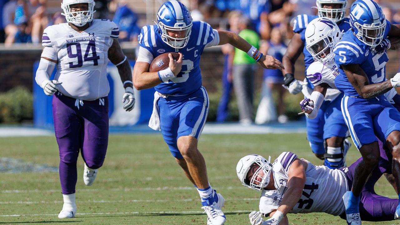 Duke's Riley Leonard, second from left, carries the ball past Northwestern's Xander Mueller (34) and R.J. Pearson (94) during the first half of an NCAA college football game in Durham, N.C., on Saturday, Sept. 16, 2023. (AP Photo/Ben McKeown)