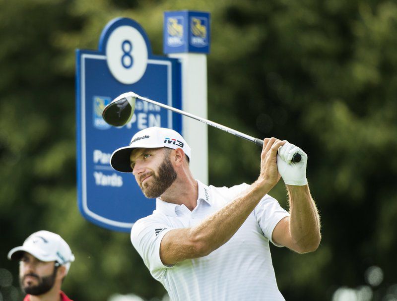 Dustin Johnson watches his tee shot on the eighth hole during the second round of the Canadian Open golf tournament at Glen Abbey in Oakville, Ontario, Friday July 27, 2018. (Nathan Denette/The Canadian Press via AP)