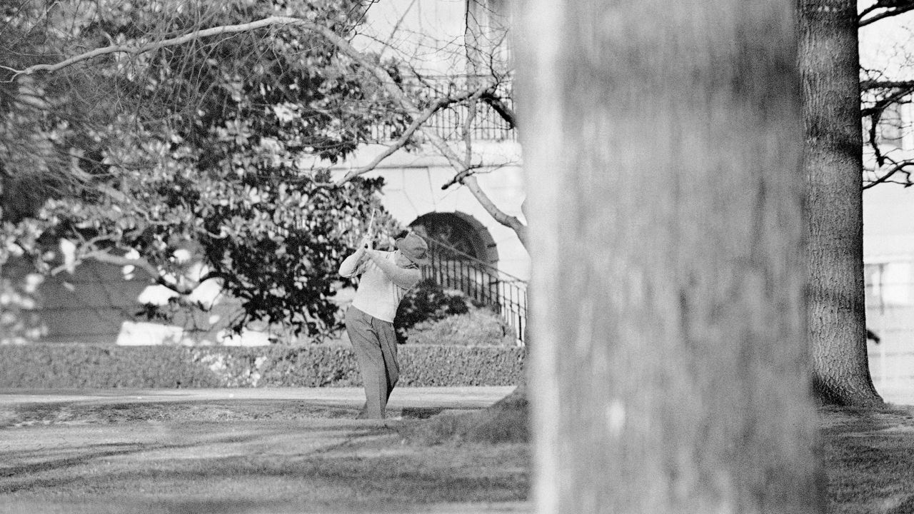 President Dwight Eisenhower brushes up on his golf game near the putting green on the lawn of the White House, Jan. 13, 1959, in Washington. (AP Photo, File)
