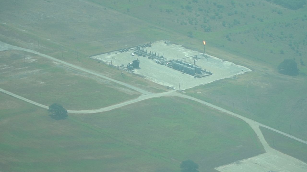 A methane flare is visible over the Eagle Ford Shale, releasing harmful pollutants and greenhouse gases into the environment. (Spectrum News 1/Dylan Scott)