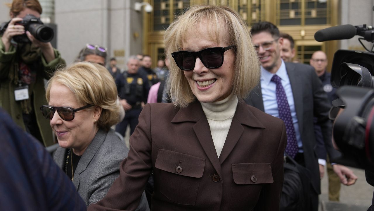 E. Jean Carroll, center, walks out of Manhattan federal court on May 9, 2023 in New York. (AP Photo/Seth Wenig)