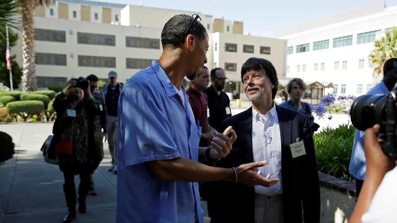 Filmmaker Ken Burns walks with inmate Rahsaan Thomas at San Quentin State Prison in San Quentin, Calif., on July 24, 2019. (AP Photo/Eric Risberg, File)